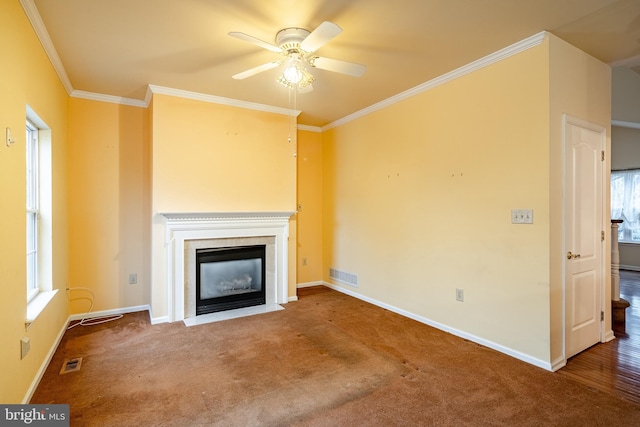 unfurnished living room with ornamental molding, carpet flooring, and ceiling fan