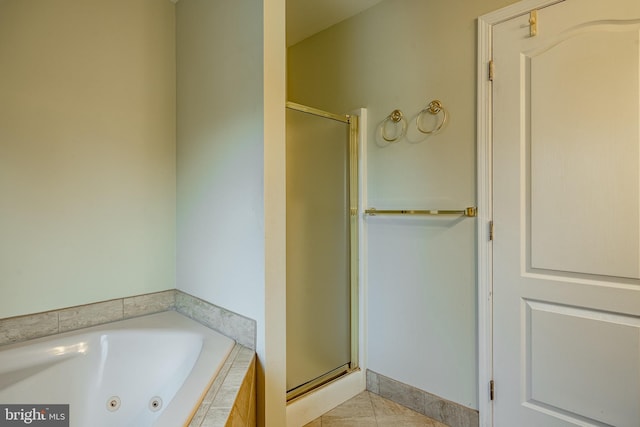 bathroom featuring tile patterned flooring and shower with separate bathtub