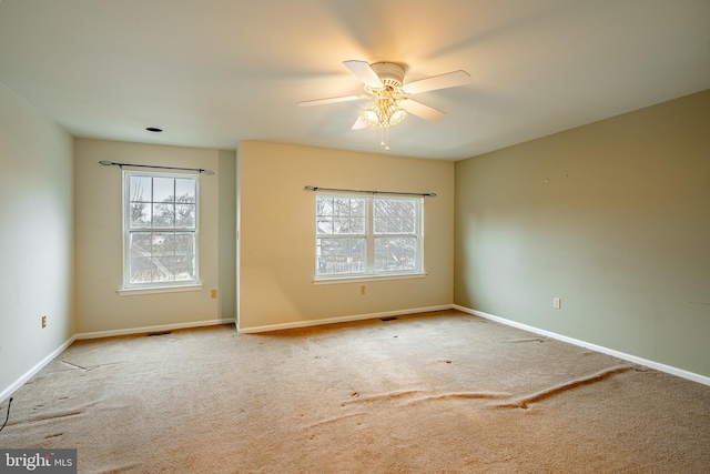 unfurnished room with ceiling fan and light colored carpet