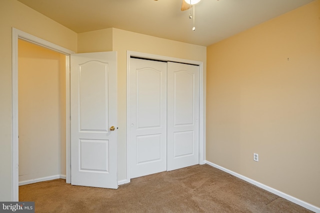 unfurnished bedroom featuring carpet floors and a closet