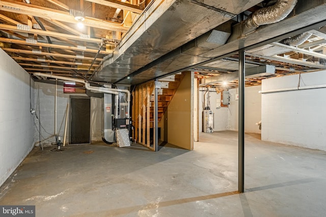 basement featuring heating unit, electric panel, and water heater