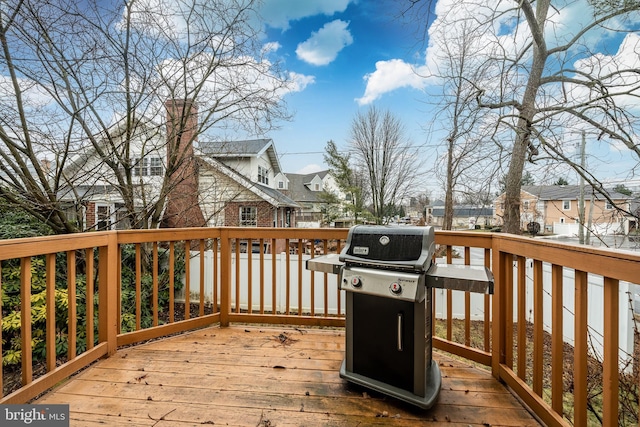 wooden deck with a grill