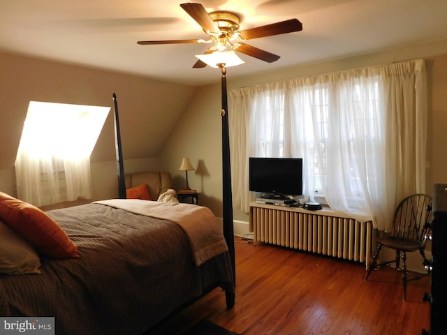 bedroom featuring lofted ceiling, radiator, hardwood / wood-style flooring, and ceiling fan