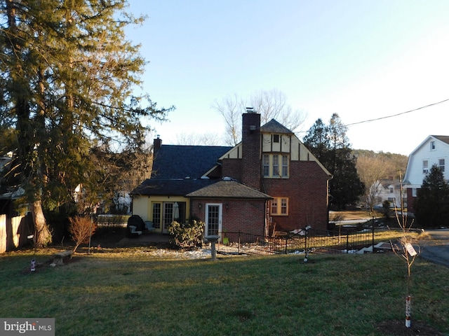 rear view of house featuring a yard