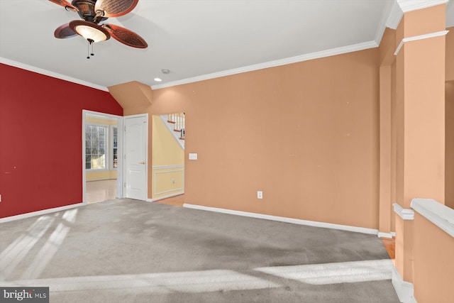 carpeted spare room featuring ceiling fan and ornamental molding