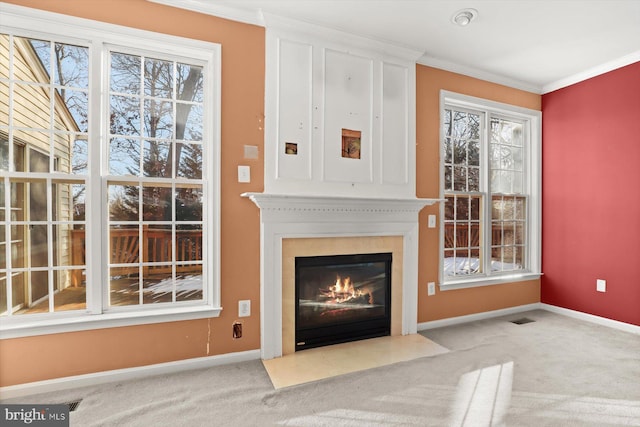 unfurnished living room with crown molding and light carpet