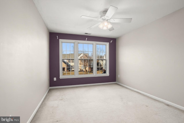 spare room featuring ceiling fan and light colored carpet