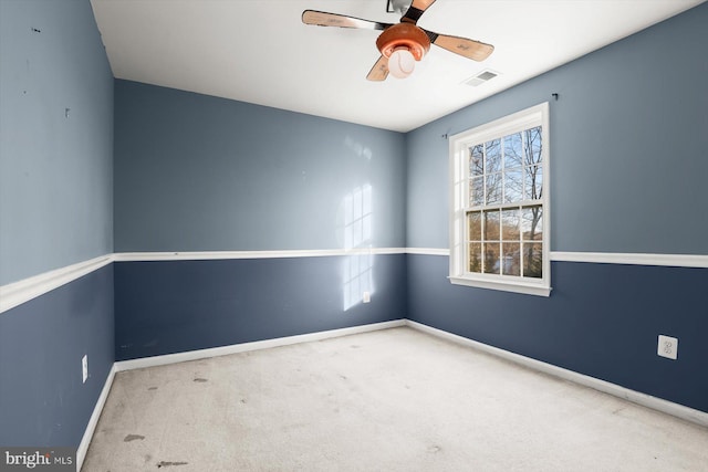 carpeted empty room featuring ceiling fan