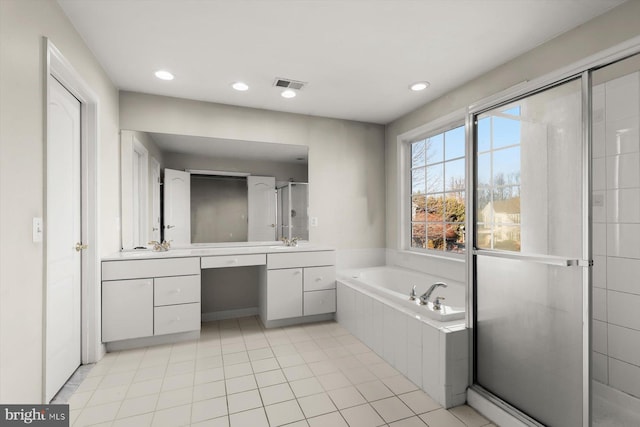 bathroom featuring independent shower and bath, vanity, and tile patterned floors