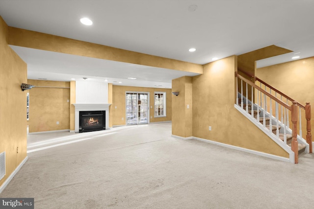 unfurnished living room featuring light carpet and a fireplace