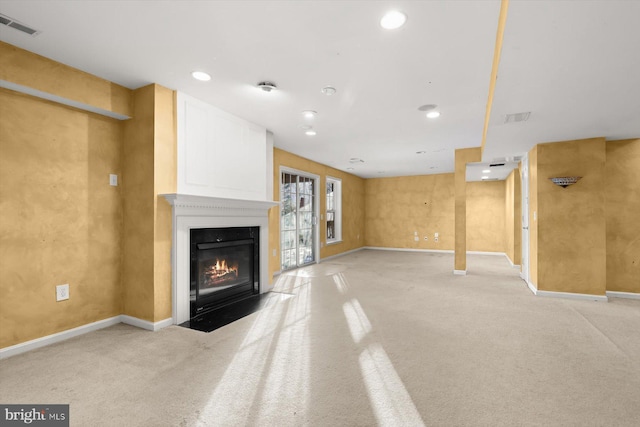 unfurnished living room with a fireplace and light carpet