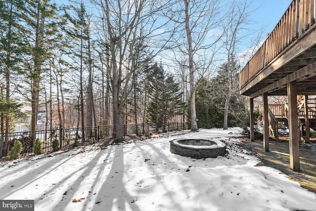 yard covered in snow featuring an outdoor fire pit