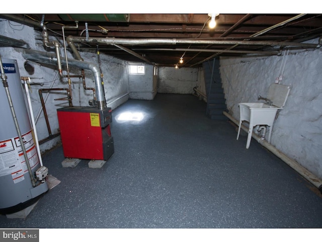 basement featuring sink and water heater