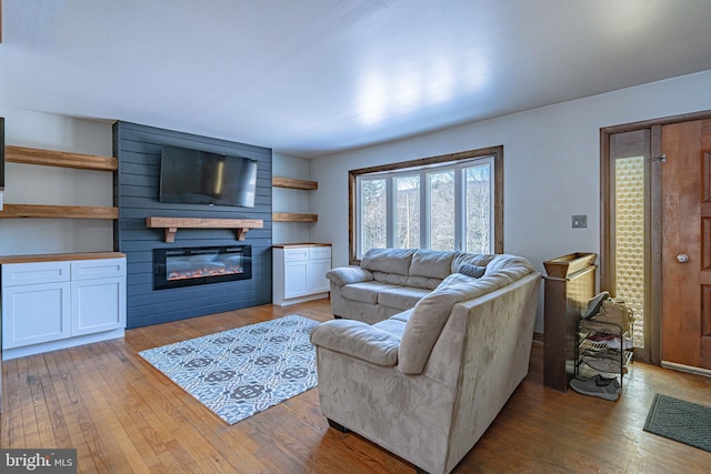 living room with a fireplace and light hardwood / wood-style floors