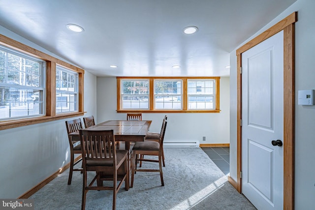 dining room featuring a baseboard heating unit and dark tile patterned floors