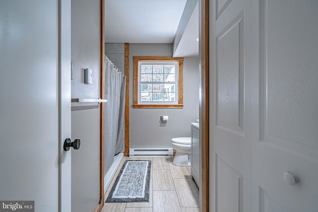 bathroom featuring vanity, curtained shower, a baseboard radiator, and toilet