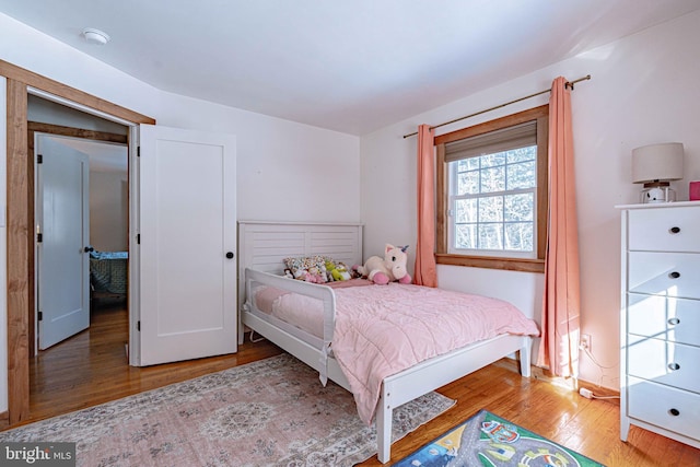 bedroom with hardwood / wood-style floors