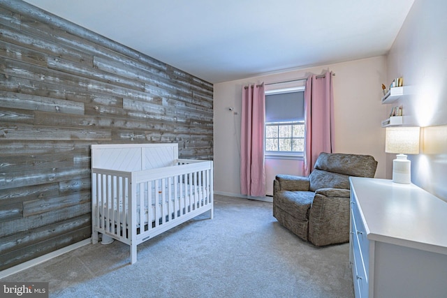 carpeted bedroom with wooden walls and a crib