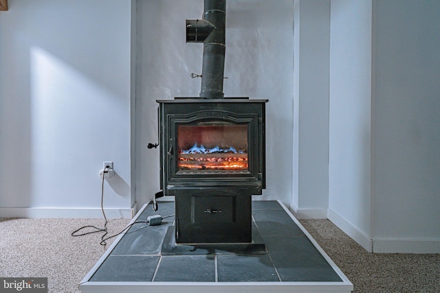 room details featuring carpet and a wood stove