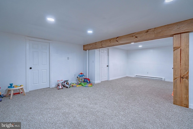 playroom featuring a baseboard heating unit and carpet flooring