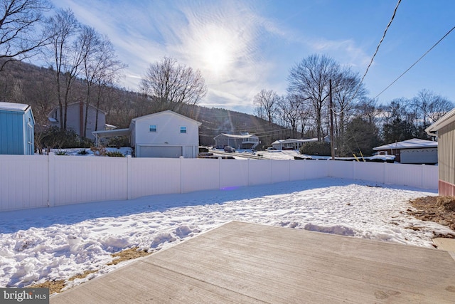 snowy yard featuring a mountain view