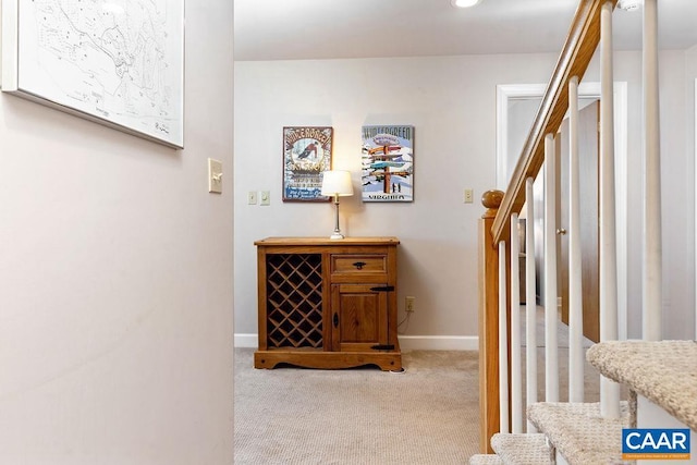 hall with light colored carpet