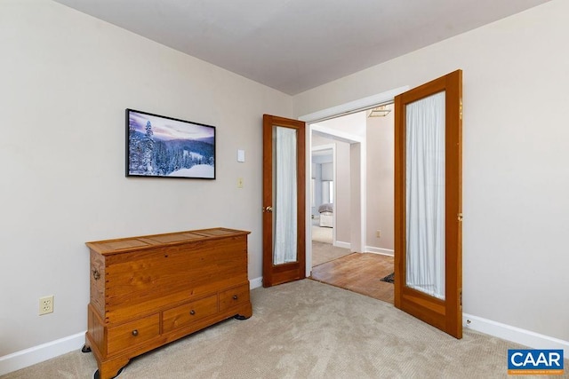 bedroom with light colored carpet and french doors