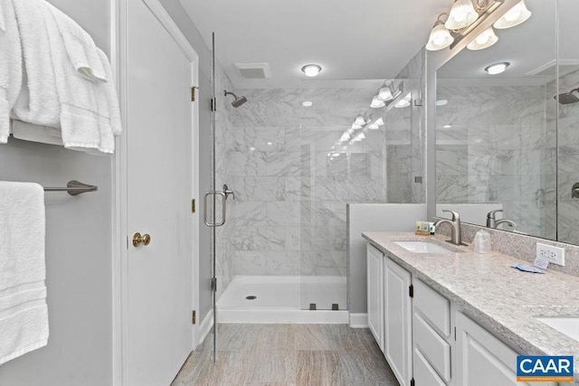 bathroom with vanity and a shower with shower door