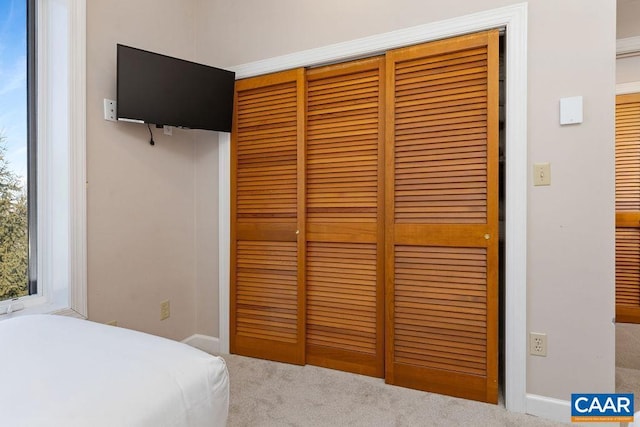 carpeted bedroom with a closet