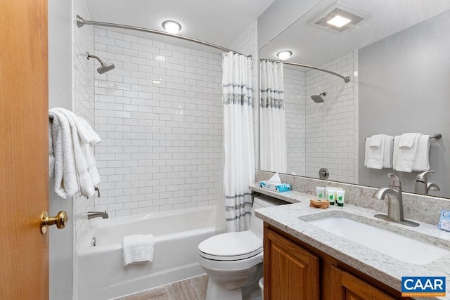 full bathroom featuring vanity, toilet, and shower / tub combo with curtain