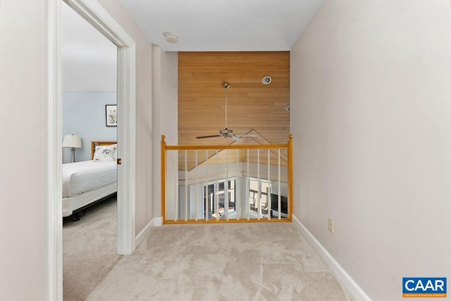 hallway featuring light colored carpet