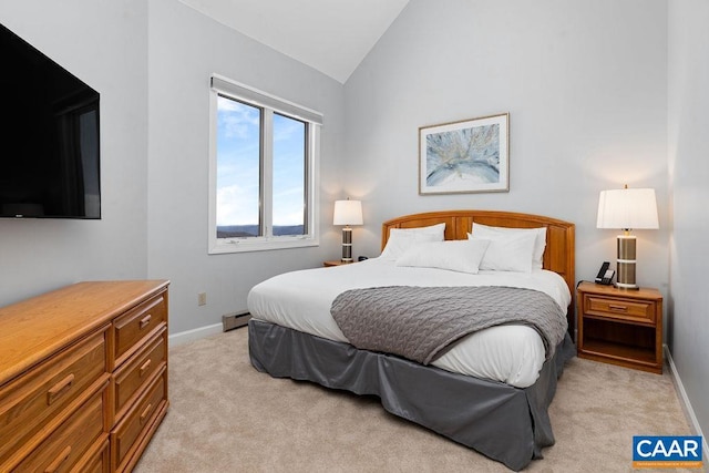 carpeted bedroom with lofted ceiling and baseboard heating