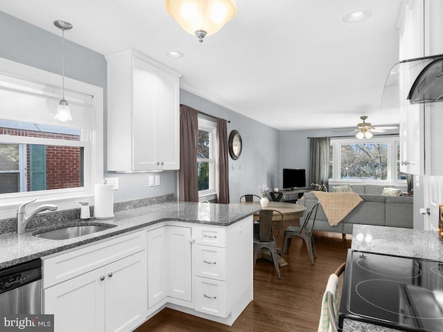 kitchen with white cabinetry, sink, and kitchen peninsula