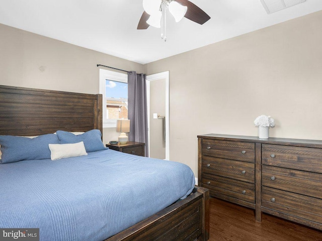 bedroom with ceiling fan and dark hardwood / wood-style floors