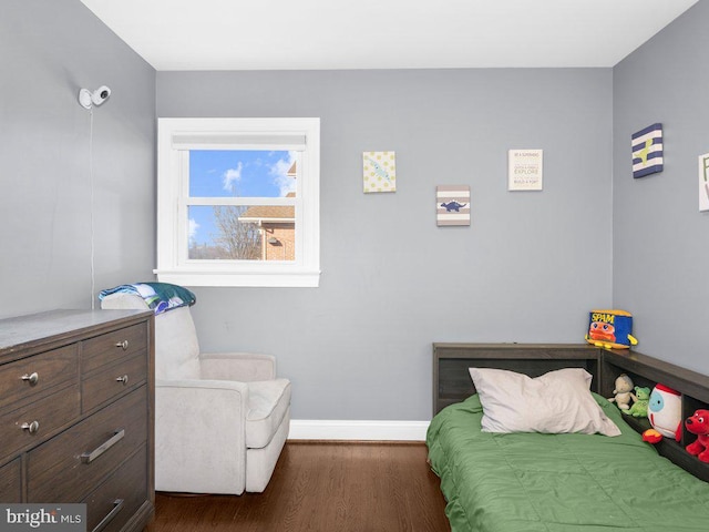 bedroom with dark hardwood / wood-style flooring