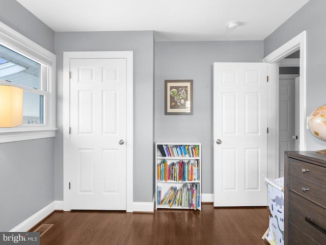 bedroom with dark hardwood / wood-style flooring