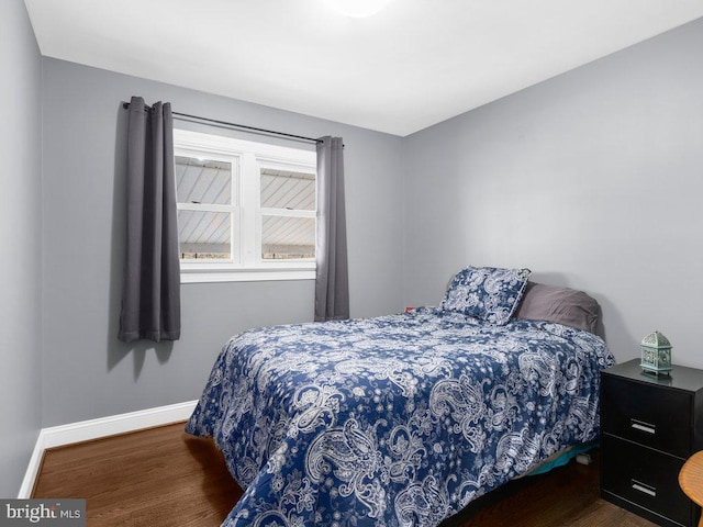 bedroom with dark hardwood / wood-style floors