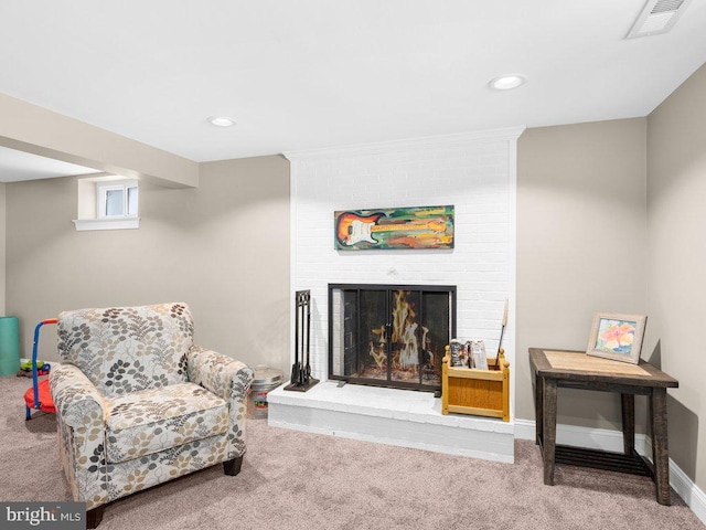 living area featuring carpet flooring and a fireplace