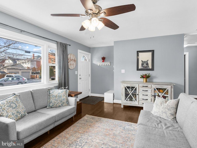 living room with dark wood-type flooring and ceiling fan