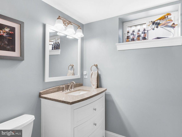 bathroom featuring vanity and toilet