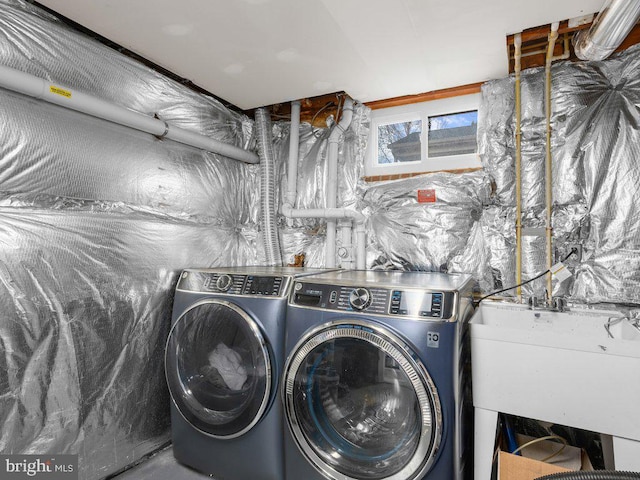 clothes washing area with sink and independent washer and dryer