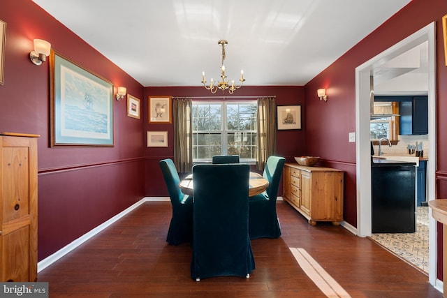 dining room with dark hardwood / wood-style floors, sink, and a notable chandelier