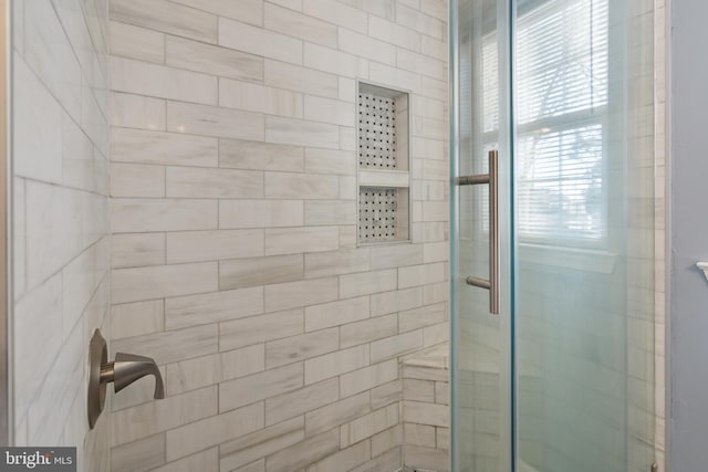 bathroom featuring a shower with shower door