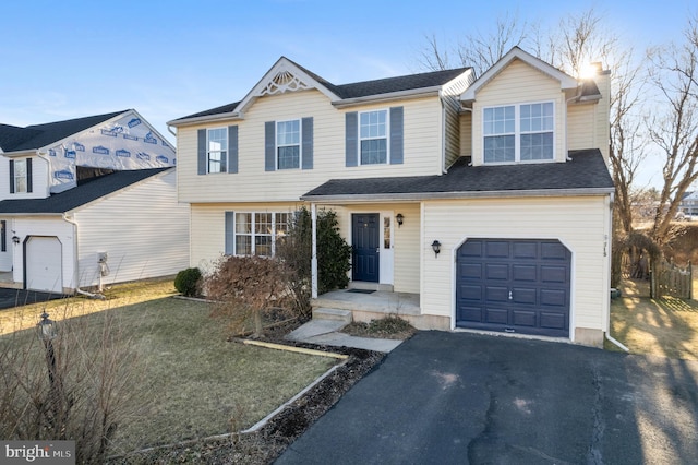 view of front of house featuring a garage and a front lawn