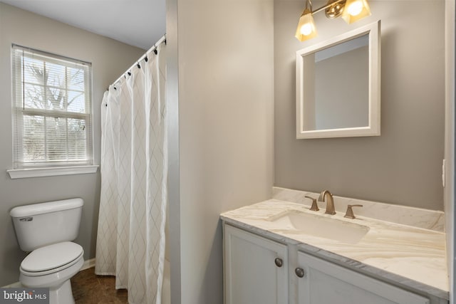 bathroom featuring walk in shower, vanity, and toilet