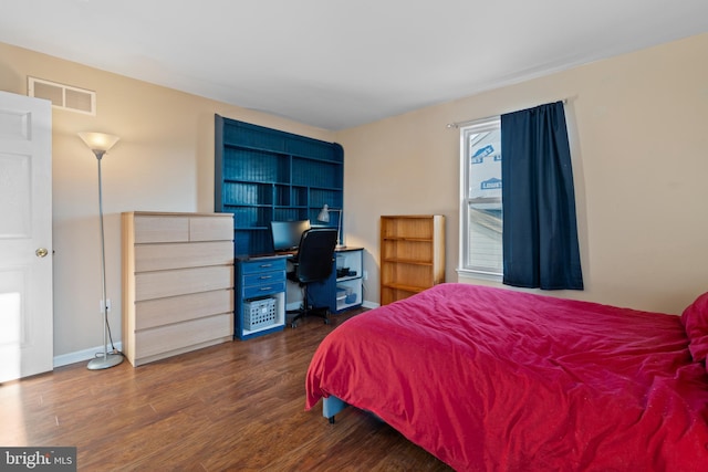 bedroom with dark wood-type flooring