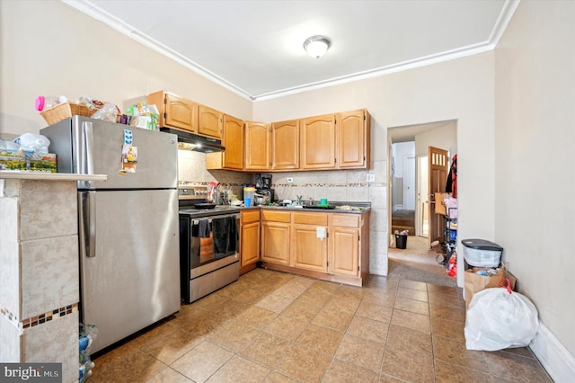 kitchen with tasteful backsplash, ornamental molding, stainless steel appliances, and light brown cabinets