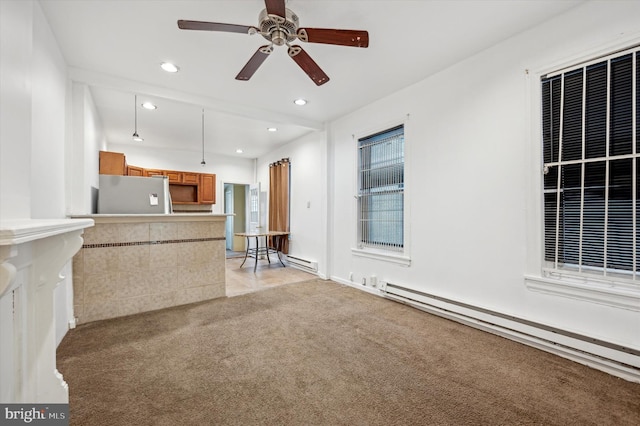 kitchen with stainless steel refrigerator, ceiling fan, light carpet, and a baseboard heating unit