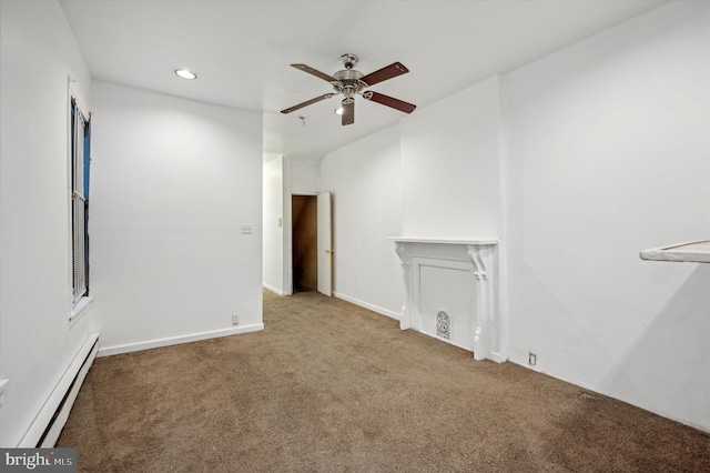 carpeted spare room featuring baseboard heating and ceiling fan