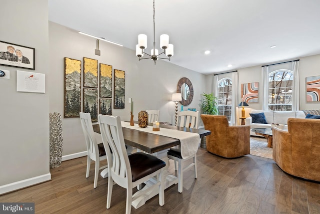 dining area featuring hardwood / wood-style flooring and a chandelier